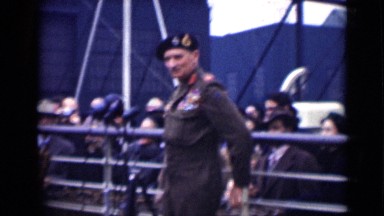 1946: High-Ranking Military Officer Waving and Giving Speech in Front of Crowd