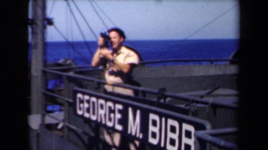 1946: person looking through lens while on large boat. NETHERLANDS