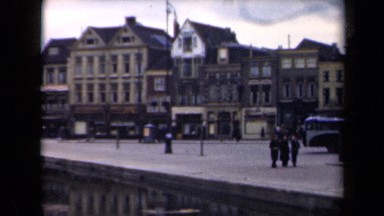 1946: part of town, in particular pier with houses and many people walking along