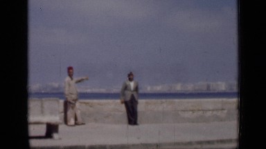 1946: two men s standing near wall behind them ocean EGYPT