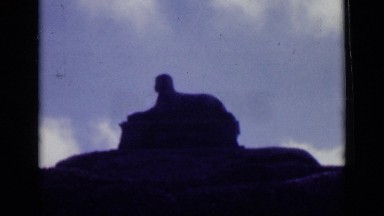 1946: sphinx statue sits on rock mound underneath partially cloudy sky EGYPT