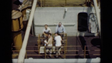 1946: group of men chatting while relaxing against railings of top deck