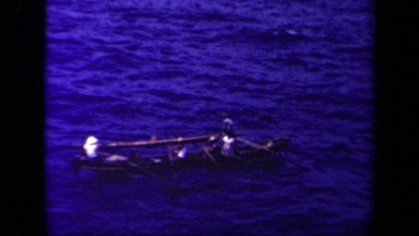 1944: people rowing small boat on blue waters of sea LEYTE GULF PHILIPPINES