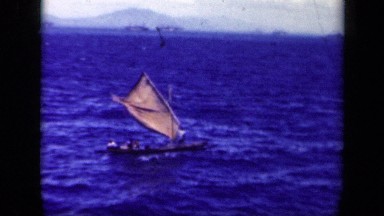 1944: small boat with passengers sailing in deep waters on windy day LEYTE GULF