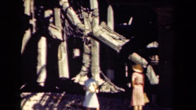 1944: two ladies are standing under collapsing building which is more dangerous