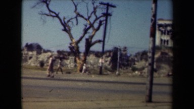 1944: the people were walking on road with building,sky,trees MANILLA
