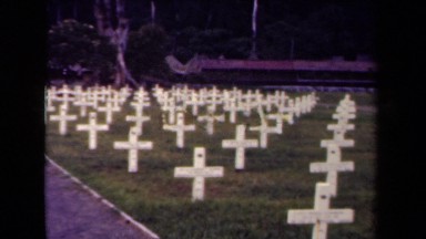 1944: graveyard with many white wooden crosses on graves