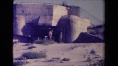1945: two men standing in front of building. FRANCE