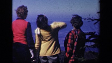 1943: three women face mountain vista laughing and talking before turning