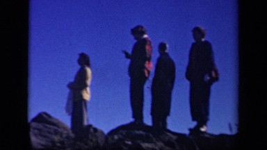 1943: group of four members are discussing something on rocks. SKYLINE DRIVE