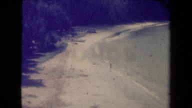 1944: black and white film of person walking into water. KAUAI HAWAII