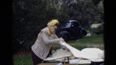 1946: Pretty Woman Hiding Behind Dining Table in London Home