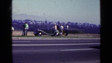 1952: Various People and Beautiful Cars Parked on Side of Busy Road with Traffic
