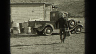 1937: man carrying what seems to be antique physician's bag walks to his pickup