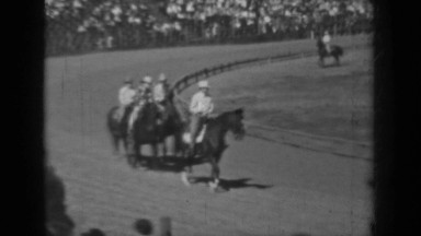 1937: the group of people sitting, watching horse race on ground KLAMATH