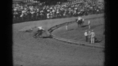 1937: horse races around track while many spectators looking around