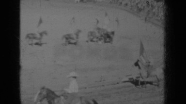 1937: Dozens of Horse Riders with Flags Perform for Audience in Klamath