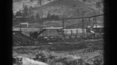 1937: crane grabbing logs and placing together KLAMATH CALIFORNIA