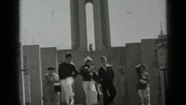 1937: young navy men in uniform walking down steps with girlfriends following