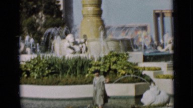 1937: people standing by waterfalls and talking to each other and pointing