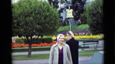 1937: people visit park with statue by fountain surrounding white tower
