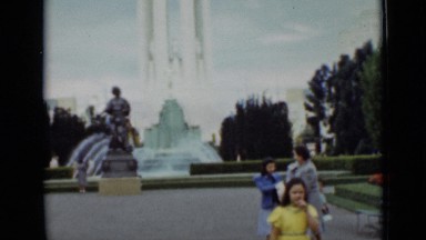 1937: two friends walking together into park and enjoying each other