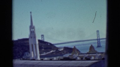 1937: san francisco bridge and ashore buildings on river coast line