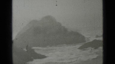 1937: the frothy waves of sea kissing large awesome rocks on shore SAN FRANCISCO