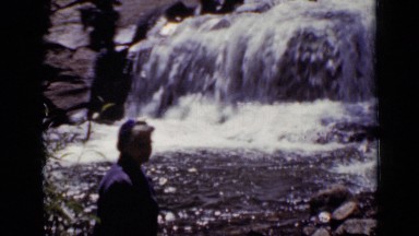 1938: women wanted to take bath in cute falls and she try to go near to water.