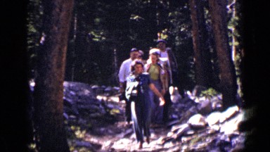 1938: woman leads five other adults as they descend path in wooded area COLORADO