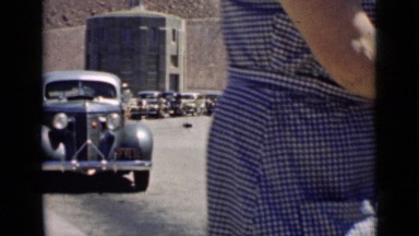 1939: woman walks in front of camera, outside of workplace. ARIZONA