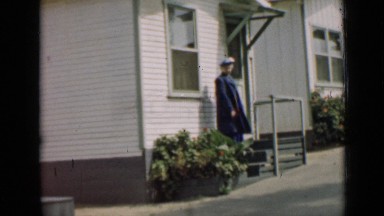 1939: lady is entering to house and watching surroundings ARIZONA