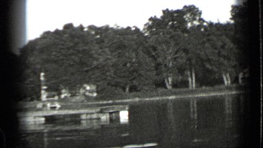 1939: lake shoreline is dotted with cabins, docks, and fishing boats CLEAR LAKE