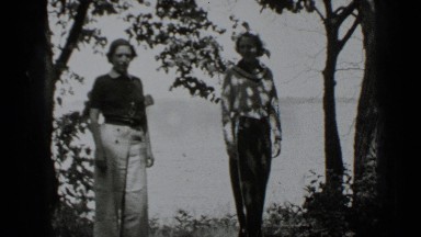 1939: two friends are standing beyond shore of some lake or sein morning CLEAR