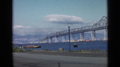 1939: runway overlooks silver bridge connecting to mountainous land