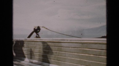 1939: shadows of people walking near to stony long wall SAN FRANCISCO