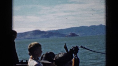 1939: people standing at bow of moving boat SAN FRANCISCO