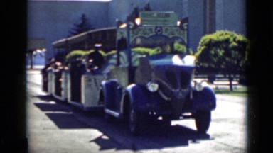 1939: moving blue toy train on track with passengers SAN FRANCISCO