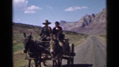 1939: two peoples are riding in donkey cart UTAH