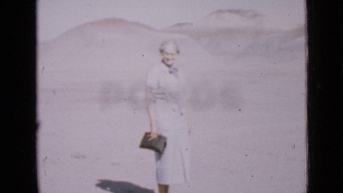 1939: old lady standing in desert with purse in hand and walking UTAH