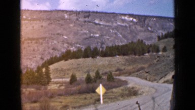 1939: very beautiful landscape containing mountain and forest and road going