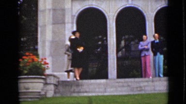 1940: some people standing at entrance of building awaiting someone CANADA