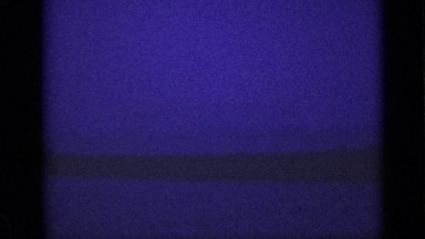 1940: dreary setting of ship with smoke coming out of top of it and purple sky