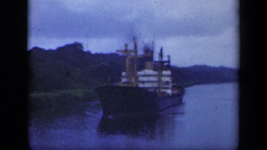 1941: very big ship making way through river alongside land NEW YORK
