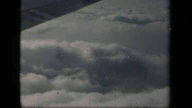 1941: the flight is flying very high in sky and clouds are passing NEW YORK