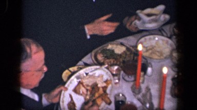 1942: several people gathered for feast at semi formal setting with meat