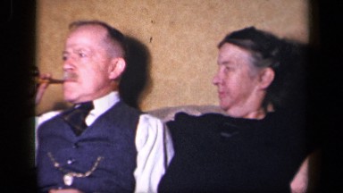 1942: old wife observing her husband enjoying cigarette SEBRING OHIO