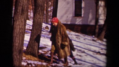 1942: women with child climbing uphill and waving hands at camera SEBRING OHIO