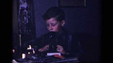1942: young boy playing with harmonica. SEBRING OHIO