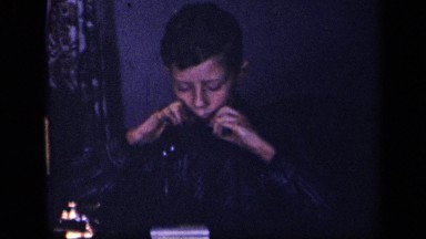 1942: school aged boy playing harmonica SEBRING OHIO
